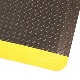 Corner product image of the black with yellow safety borders and embossed diamond pattern