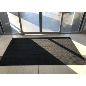 Installation of the Waterhog mat in a shopping centre, it remains fresh looking after heavy foot traffic.