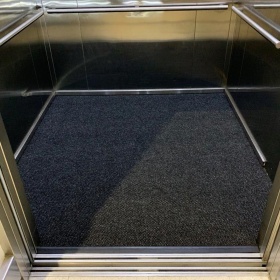 Image of a Hydrasorb mat, custom sized to fit into an elevator for a commerical building.