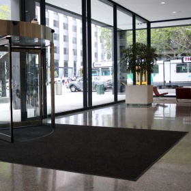 Image of a super guard entrance mat with a custom size cut, edging and installtion into a commerical building lobby.