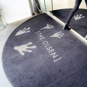 Insitu product of a PrintPlush Logo Mat installation for a revolving door in a commerical building.
