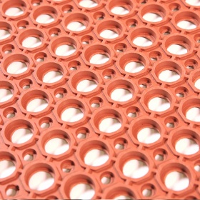 Close up image of the terracotta, slip resistant holes for drainage perfect for work stations